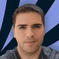 A man is standing in front of a striped background.