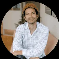 An image of a man sitting on a couch.